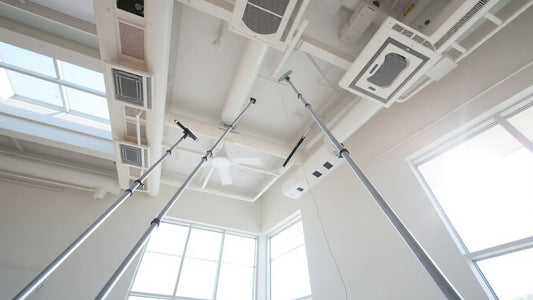 Long high-reach dusting poles extending towards a clean ceiling.