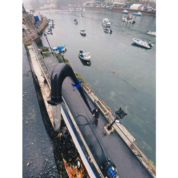 SkyVac Elite Hairpin Carbon Fiber Tool Holder for Gutter Cleaning Action Photo near water